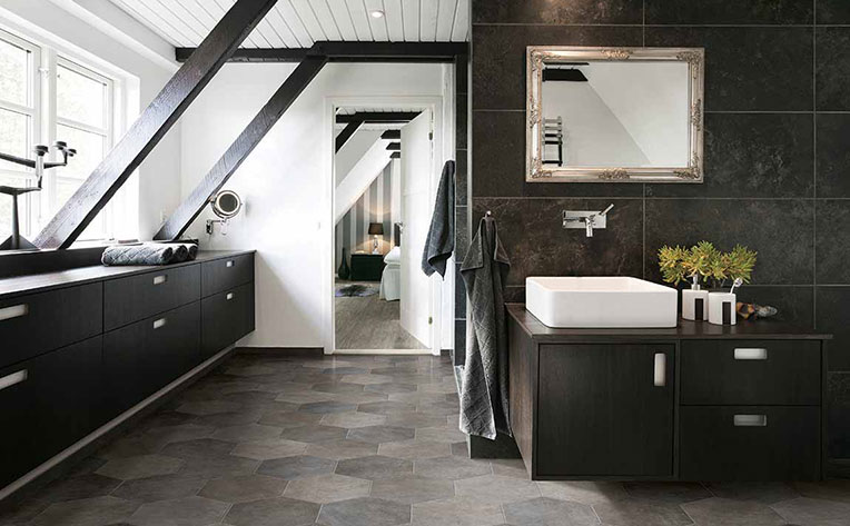 Modern 2020 bathroom with white washbasin sink on a free-standing cabinet, silver fixtures, and hexagon-shaped floor tiles.